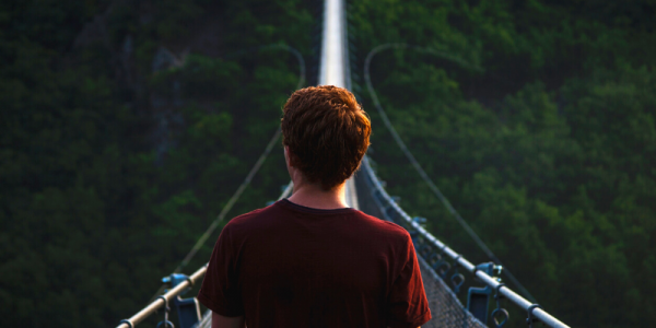 Photo: Explorer walking over rope bridge